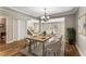 Dining area with a modern chandelier, wooden table for six, and seamless flow to the living spaces at 1106 Hampton Ne Way, Atlanta, GA 30324