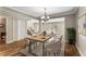 Bright dining room showcasing an elegant chandelier, seating for six, and wood-look tile floors at 1106 Hampton Ne Way, Atlanta, GA 30324