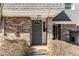 Close-up of a gray front door with sidelight, brick facade, and unit number 1106 at 1106 Hampton Ne Way, Atlanta, GA 30324