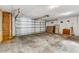 Spacious garage with a metal door, concrete floor, and plenty of room for parking and storage at 1106 Hampton Ne Way, Atlanta, GA 30324