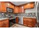 A modern kitchen featuring stainless steel appliances and wooden cabinetry at 1106 Hampton Ne Way, Atlanta, GA 30324
