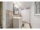 Bright bathroom features a white vanity, shower with white curtain, and stylish neutral tile at 2101 Newgate Dr, Decatur, GA 30035