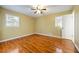 Bright bedroom with hardwood floors, two windows for natural light and a ceiling fan at 2101 Newgate Dr, Decatur, GA 30035