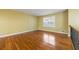 Bright living room featuring gleaming hardwood floors, neutral walls, and natural light from a large window at 2101 Newgate Dr, Decatur, GA 30035