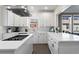 Bright, updated kitchen with white cabinetry, stainless steel appliances, and quartz countertops at 220 Mayson Ne Ave, Atlanta, GA 30307