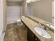 Bathroom with granite countertop, basin sink, tub, and wood look flooring at 265 Edinburgh Ln, Woodstock, GA 30188