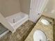 Bathroom featuring soaking tub and double granite sink at 265 Edinburgh Ln, Woodstock, GA 30188