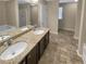 Bathroom with granite countertop, double basin sink, tub, and wood look flooring at 265 Edinburgh Ln, Woodstock, GA 30188