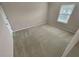The bedroom features neutral colored walls, carpeted floors, and a window for natural light at 265 Edinburgh Ln, Woodstock, GA 30188