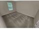 Cozy bedroom featuring plush carpet and a window letting in natural light at 265 Edinburgh Ln, Woodstock, GA 30188