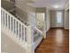 Inviting home interior with stairs leading up, wood floors, and neutral paint, and access to the front door at 265 Edinburgh Ln, Woodstock, GA 30188