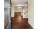 Bright entryway with gleaming hardwood floors, a staircase, and an open view of the living area at 265 Edinburgh Ln, Woodstock, GA 30188