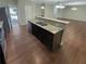 Open concept kitchen with island featuring stainless steel appliances and a seamless transition to the living area at 265 Edinburgh Ln, Woodstock, GA 30188