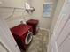 Laundry room with red washer and dryer units and storage shelf at 265 Edinburgh Ln, Woodstock, GA 30188