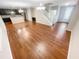 Bright, open-concept living space with hardwood floors connecting to a modern kitchen at 265 Edinburgh Ln, Woodstock, GA 30188