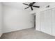 Bedroom featuring light gray carpet, a ceiling fan, and a closet with louvered doors at 2979 Grey Squirrel Se Ct, Marietta, GA 30067