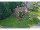 Aerial view of home with verdant lawn and landscaping on a cul-de-sac lot surrounded by mature trees at 403 Glenhurst Trce, Canton, GA 30115