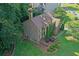 Stunning aerial view of a well-manicured brick home with lush landscaping, mature trees, and a driveway at 403 Glenhurst Trce, Canton, GA 30115