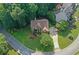 Aerial view of a beautifully landscaped home nestled on a large lot with mature trees and a curved driveway at 403 Glenhurst Trce, Canton, GA 30115