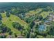 Aerial view of lush Woodmont Golf & Country Club golf course with surrounding neighborhood at 403 Glenhurst Trce, Canton, GA 30115