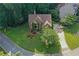 Overhead view of lovely brick home on meticulously maintained lawn and manicured landscaping with mature trees at 403 Glenhurst Trce, Canton, GA 30115
