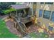 Aerial view of the backyard with a deck and staircase leading to a well-maintained lawn and surrounding landscape at 403 Glenhurst Trce, Canton, GA 30115
