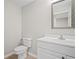 Bathroom featuring a toilet, vanity, and framed mirror at 403 Glenhurst Trce, Canton, GA 30115