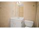 Well-lit bathroom featuring a white vanity, framed mirror, and fixtures, with a toilet on the side at 403 Glenhurst Trce, Canton, GA 30115
