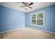 Serene bedroom with light blue walls, neutral carpet, and a window offering natural light and a view at 403 Glenhurst Trce, Canton, GA 30115
