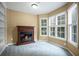 Cozy bonus room featuring a fireplace, built-in shelving, and plenty of natural light from the surrounding windows at 403 Glenhurst Trce, Canton, GA 30115