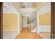 An inviting foyer featuring hardwood floors and access to the upper level with views of adjacent rooms at 403 Glenhurst Trce, Canton, GA 30115