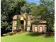 Charming two-story brick home with a well-manicured lawn and mature trees at 403 Glenhurst Trce, Canton, GA 30115