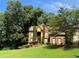 Beautiful two-story brick home surrounded by lush greenery and mature trees at 403 Glenhurst Trce, Canton, GA 30115