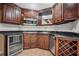 This updated kitchen features dark wood cabinetry, stainless appliances, a wine rack, and granite countertops at 403 Glenhurst Trce, Canton, GA 30115