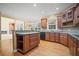 Spacious open kitchen features granite countertops, hardwood floors and ample cabinet space at 403 Glenhurst Trce, Canton, GA 30115