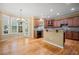 Bright, open kitchen features granite countertops, wood cabinets, and stainless appliances at 403 Glenhurst Trce, Canton, GA 30115