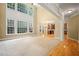 Bright living room with large windows and neutral carpet flooring offers a cozy, inviting space at 403 Glenhurst Trce, Canton, GA 30115