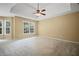 Spacious main bedroom with a tray ceiling, ceiling fan, and large windows for natural light at 403 Glenhurst Trce, Canton, GA 30115