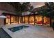 Beautiful backyard featuring a pool, stone patio, and a covered outdoor seating area at 4975 Rebel Trl, Atlanta, GA 30327