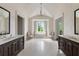 Bright bathroom with tub, double vanities, natural light, and modern chandelier at 4975 Rebel Trl, Atlanta, GA 30327