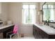 Bright bathroom with a vanity, makeup counter, and a large window providing ample natural light at 4975 Rebel Trl, Atlanta, GA 30327