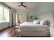 Stylish bedroom with a tufted headboard, hardwood floors, and soft blue walls at 4975 Rebel Trl, Atlanta, GA 30327