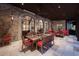 Outdoor dining area with stone flooring, arched windows, and comfortable seating arrangement at 4975 Rebel Trl, Atlanta, GA 30327