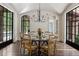 Elegant dining room with wood table, seating for eight, arched ceiling, and views of the pool at 4975 Rebel Trl, Atlanta, GA 30327