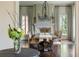 Formal dining room with decorative chandelier, hardwood floors, and large windows with custom draperies at 4975 Rebel Trl, Atlanta, GA 30327