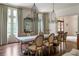 Elegant dining room featuring a rustic table, chandelier, hardwood floors, and natural light at 4975 Rebel Trl, Atlanta, GA 30327