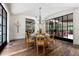 Elegant dining room featuring hardwood floors, vaulted ceilings, chandelier, and walls of glass at 4975 Rebel Trl, Atlanta, GA 30327