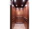Modern wooden elevator featuring paneled walls, wooden floors, and recessed lighting at 4975 Rebel Trl, Atlanta, GA 30327