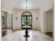 Grand foyer with arched doorway, chandelier, and stone tile flooring at 4975 Rebel Trl, Atlanta, GA 30327