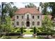 A stately stone home with manicured front lawn, fountain, and balanced design at 4975 Rebel Trl, Atlanta, GA 30327